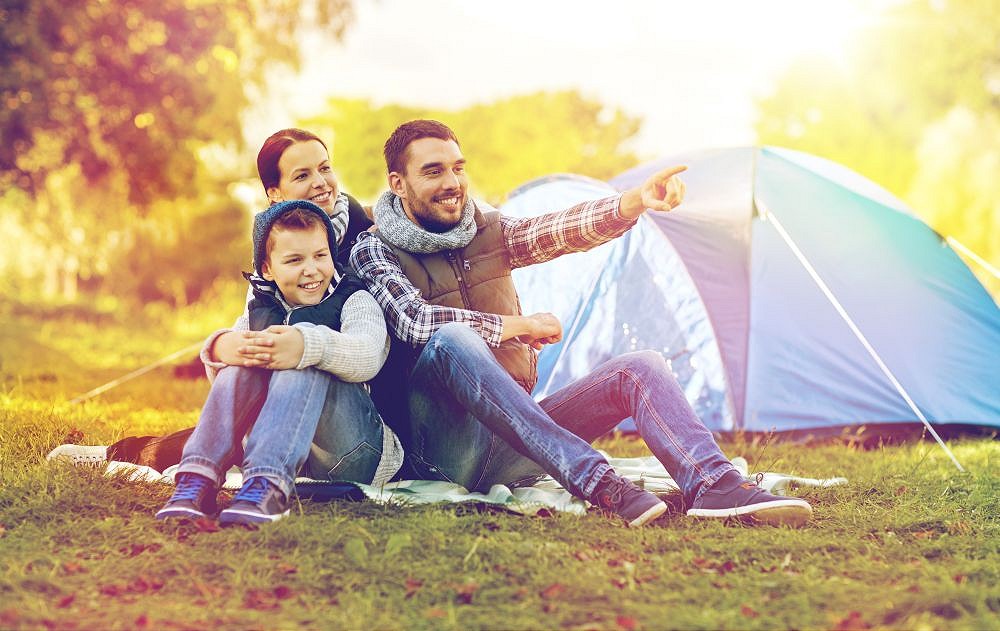 happy family with tent at camp site