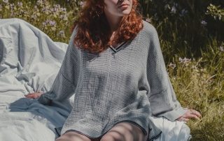 woman demonstrates deep breathing outdoors, one of the best relaxation exercises for anxiety