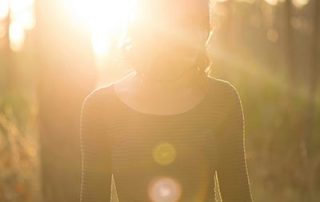 woman-standing-in-a-sun-flare